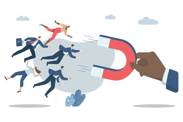 A vector illustration of a businessman's hand holding a magnet, symbolizing outbound marketing strategies for B2B to attract and engage clients.