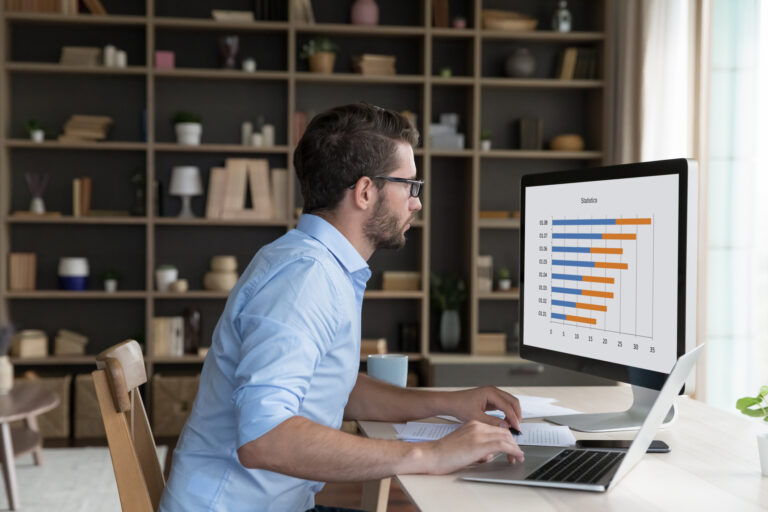 Young marketing professional reviewing last week’s PPC campaign results after implementing AI Max in Google Ads