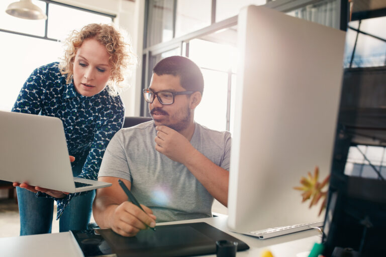 Two professionals analyzing marketing data together as paid ad traffic stops converting and performance declines