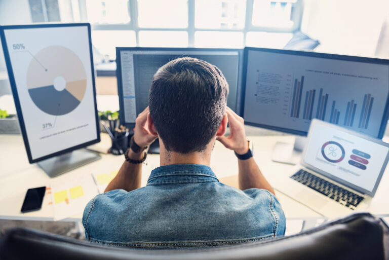 Marketing professional analyzing PPC campaign data on a laptop while evaluating data accuracy and reporting gaps