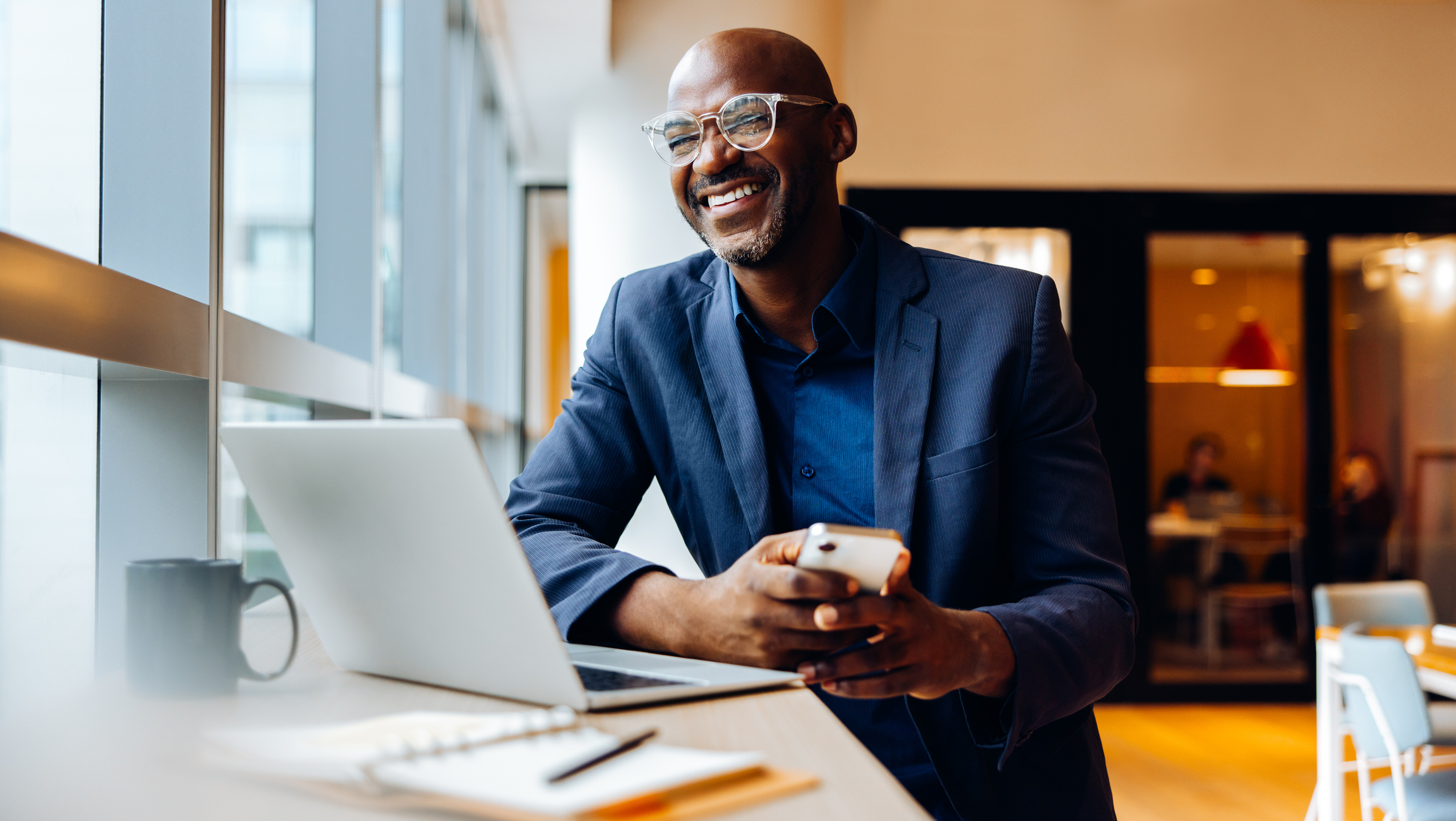 Business professional reviewing a PPC landing page strategy on a laptop before taking the next step